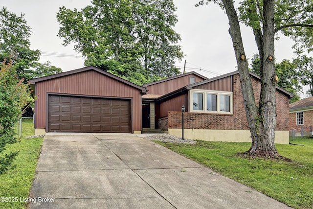 9313 Plumwood Pl, Crestwood, KY 40014 - mid-century inspired home featuring concrete driveway, an attached garage, and brick siding