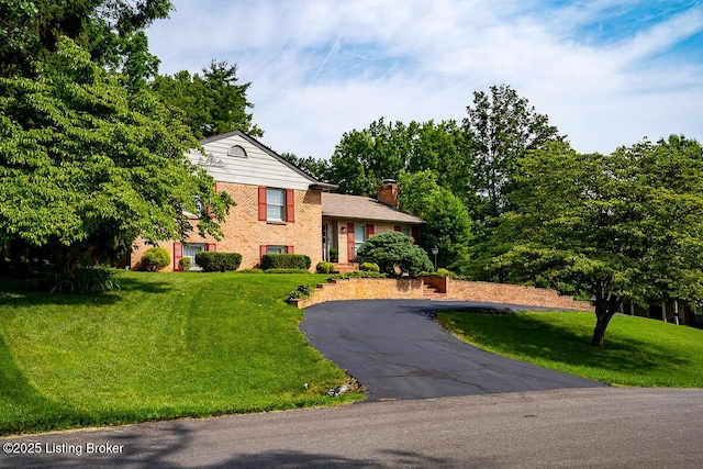1824 Knollwood Rd, Louisville, KY 40207 - tri-level home featuring brick siding, a chimney, a front yard, and driveway