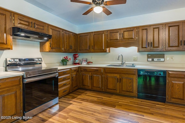 1824 Knollwood Rd, Louisville, KY 40207 - kitchen with stainless steel electric range, dishwasher, under cabinet range hood, and light countertops