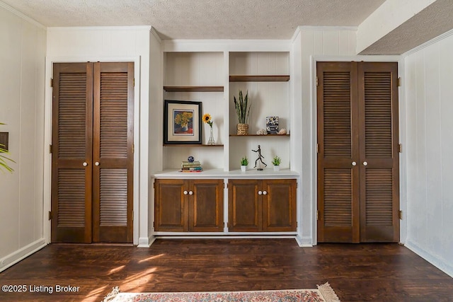 1824 Knollwood Rd, Louisville, KY 40207 - bedroom with ornamental molding, dark wood-style floors, a textured ceiling, a decorative wall, and multiple closets