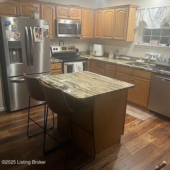 192 Patrum Sisters Way, Danville, KY 40422 - kitchen featuring stainless steel appliances, dark wood-style floors, a kitchen island, and a kitchen bar