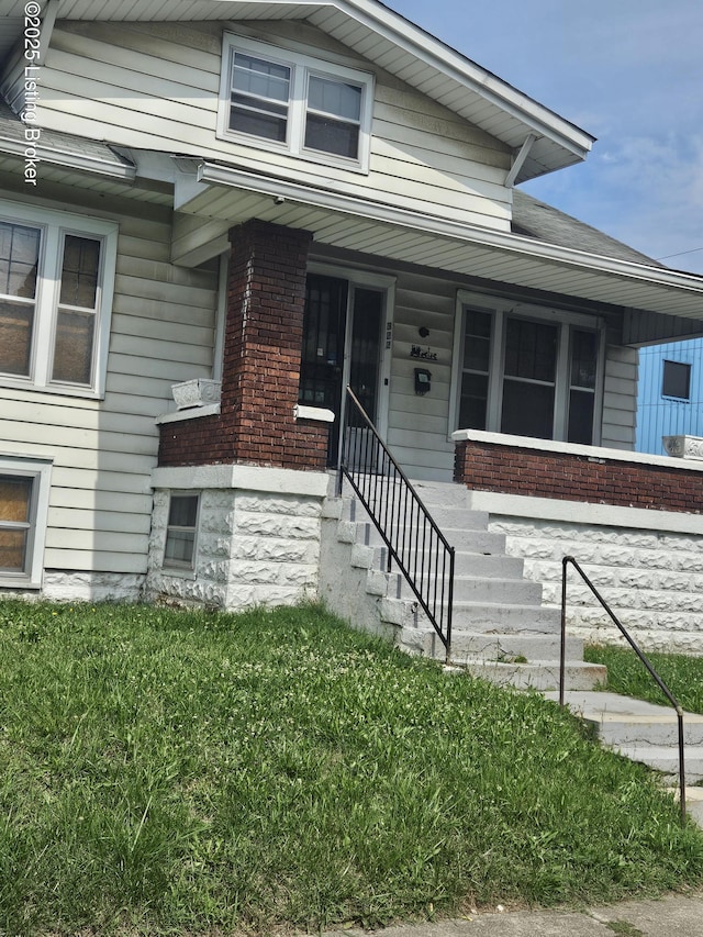 322 N 32nd St, Louisville, KY 40212 - view of front of property featuring stairs, brick siding, and a front yard