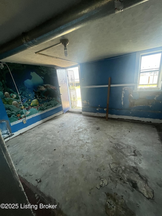 322 N 32nd St, Louisville, KY 40212 - unfurnished room featuring healthy amount of natural light and unfinished concrete floors