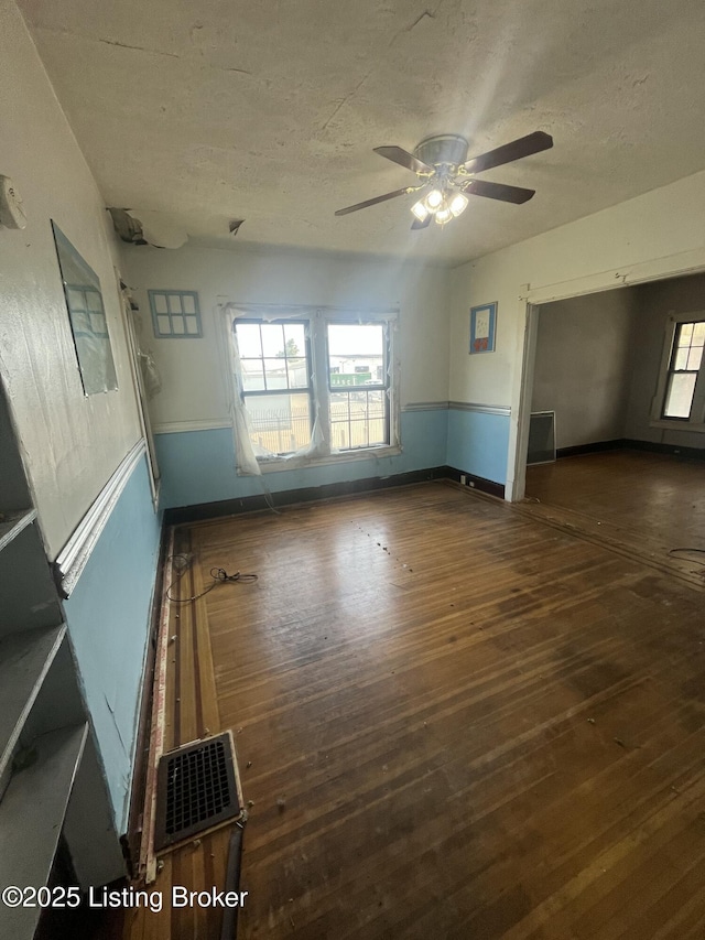 322 N 32nd St, Louisville, KY 40212 - empty room featuring wood-type flooring, a ceiling fan, plenty of natural light, and a textured ceiling