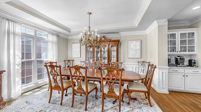 3221 Overlook Ridge Rd, Prospect, KY 40059 - dining area with light wood finished floors, a chandelier, a raised ceiling, ornamental molding, and a wainscoted wall