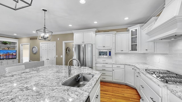 3221 Overlook Ridge Rd, Prospect, KY 40059 - kitchen featuring stainless steel appliances, custom range hood, recessed lighting, ornamental molding, and white cabinetry