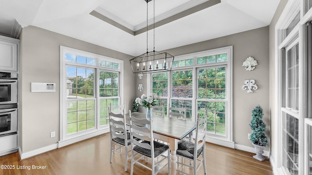 3221 Overlook Ridge Rd, Prospect, KY 40059 - dining space featuring healthy amount of natural light, a chandelier, light wood-style floors, a tray ceiling, and ornamental molding