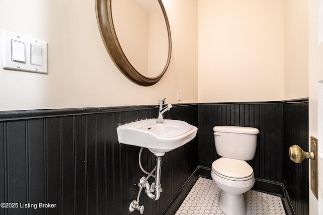 1629 S 3rd St Apt 102, Louisville, KY 40208 - half bath featuring a wainscoted wall and tile patterned floors