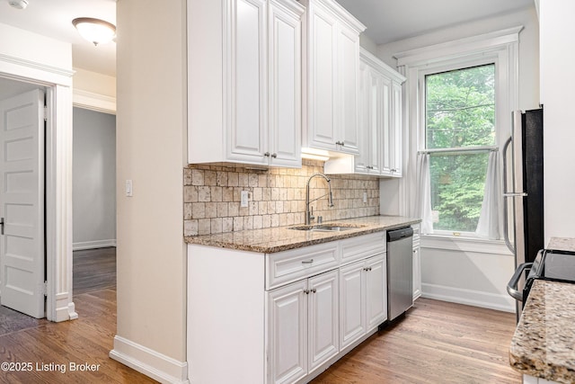 1629 S 3rd St Apt 102, Louisville, KY 40208 - kitchen featuring dishwasher, white cabinets, healthy amount of natural light, and light wood-style flooring