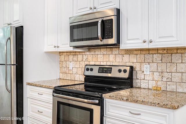 1629 S 3rd St Apt 102, Louisville, KY 40208 - kitchen with stainless steel appliances, white cabinetry, backsplash, and light stone counters