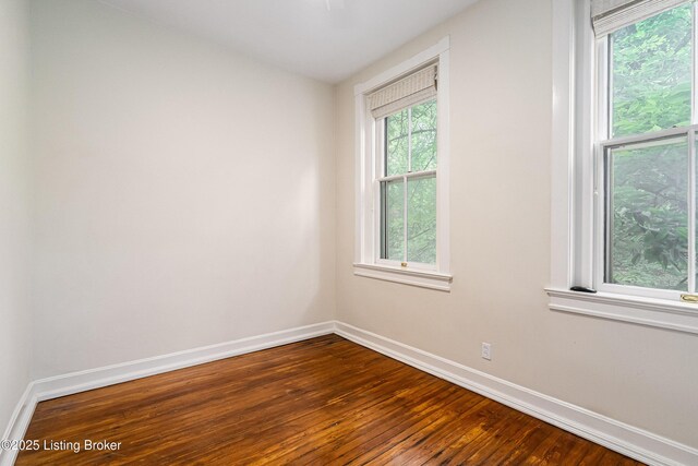 1629 S 3rd St Apt 102, Louisville, KY 40208 - empty room with baseboards and dark wood-type flooring