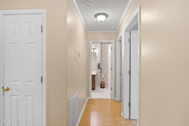 8001 Port Royal Ct, Louisville, KY 40291 - hallway featuring a textured ceiling, crown molding, and light wood finished floors