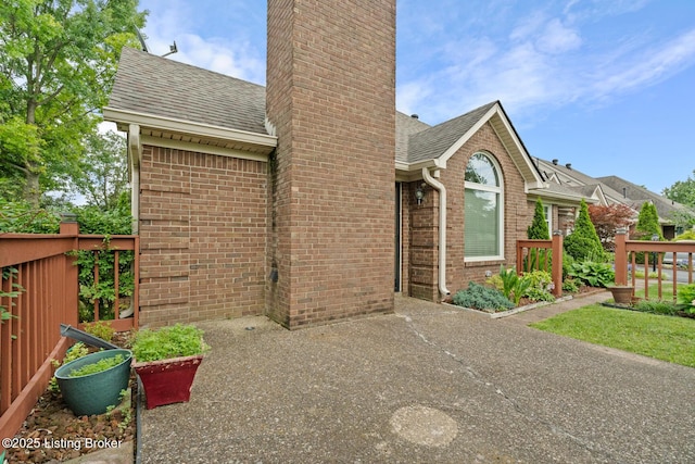 8001 Port Royal Ct, Louisville, KY 40291 - view of front facade with roof with shingles, brick siding, and a chimney