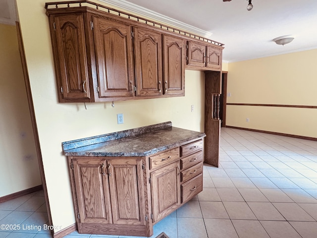 5019 S Wilson Rd, Elizabethtown, KY 42701 - kitchen with dark countertops, crown molding, and light tile patterned floors