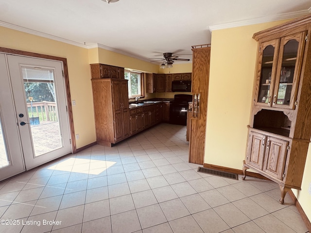 5019 S Wilson Rd, Elizabethtown, KY 42701 - kitchen with black microwave, plenty of natural light, crown molding, light tile patterned floors, and ceiling fan
