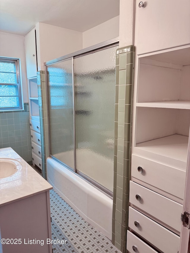 5019 S Wilson Rd, Elizabethtown, KY 42701 - full bath featuring bath / shower combo with glass door, vanity, and tile walls