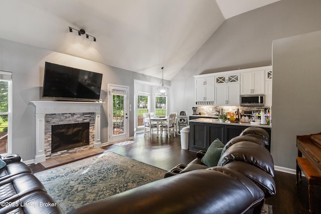 3506 Coventry Tee Ct, Louisville, KY 40241 - living room featuring high vaulted ceiling, dark wood-type flooring, and a stone fireplace
