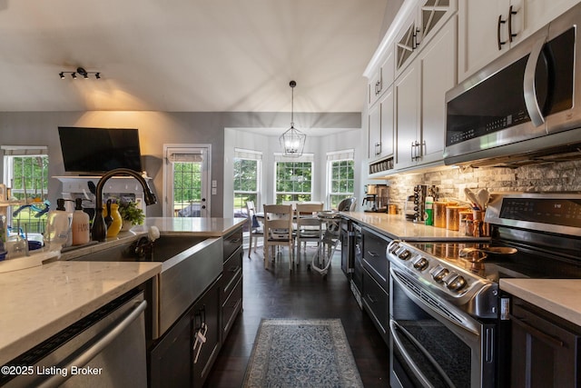 3506 Coventry Tee Ct, Louisville, KY 40241 - kitchen featuring appliances with stainless steel finishes, white cabinets, a chandelier, decorative backsplash, and dark wood-style floors