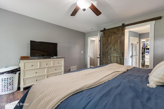 3506 Coventry Tee Ct, Louisville, KY 40241 - bedroom featuring dark wood-style flooring, a barn door, and ceiling fan