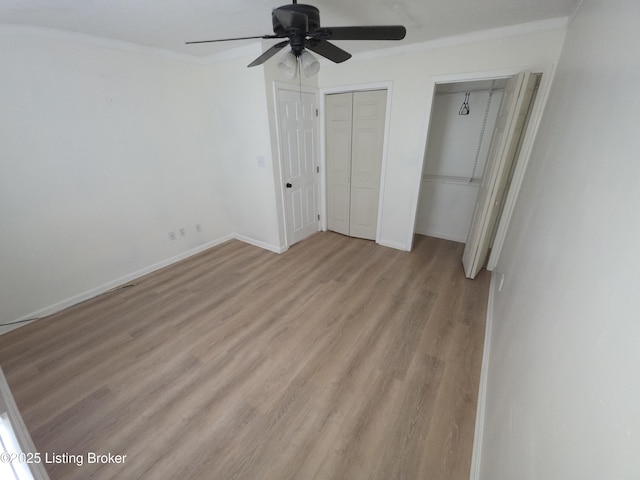 8308 Lake Superior Dr, Louisville, KY 40291 - unfurnished bedroom with light wood-style flooring, two closets, crown molding, and a ceiling fan