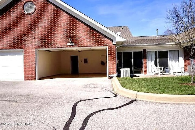 7816 Turtle Run Ct #, Ct-F Prospect, KY 40059 - view of home's exterior with brick siding, asphalt driveway, and a garage