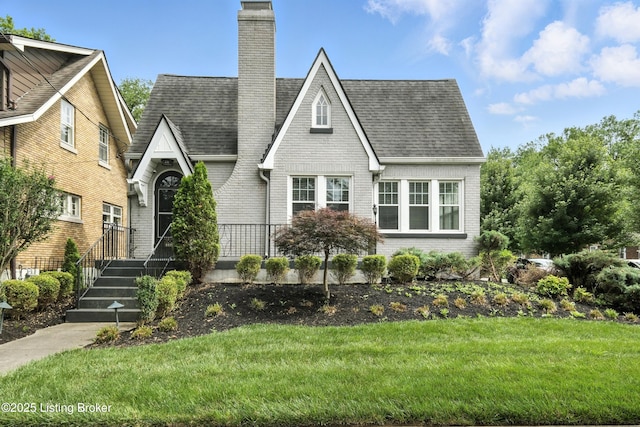 3500 Lexington Rd, Louisville, KY 40207 - view of front of property with brick siding, a chimney, a front yard, and roof with shingles