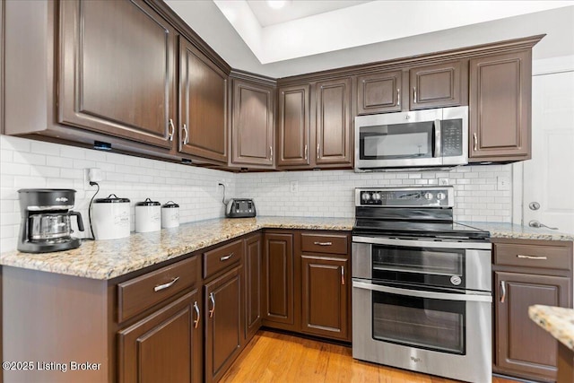 9311 Artis Way, Louisville, KY 40291 - kitchen featuring stainless steel appliances, light stone countertops, and dark brown cabinetry