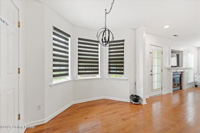 9311 Artis Way, Louisville, KY 40291 - unfurnished dining area featuring a chandelier, plenty of natural light, and hardwood / wood-style floors