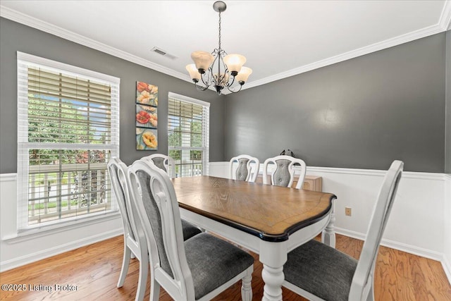 9311 Artis Way, Louisville, KY 40291 - dining area with a chandelier, light wood-style floors, and ornamental molding