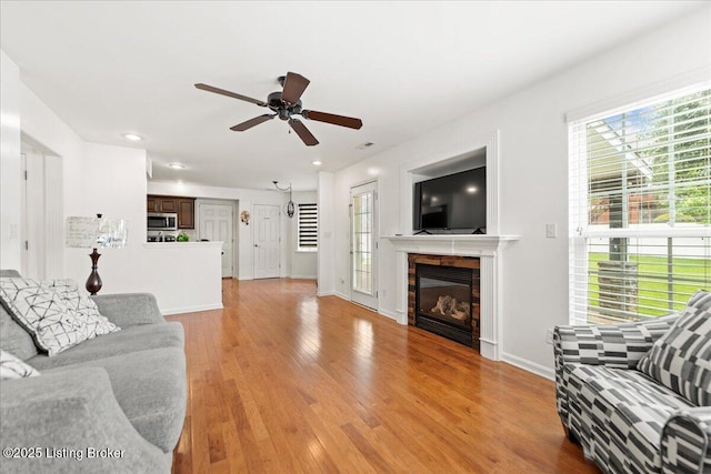 9311 Artis Way, Louisville, KY 40291 - living area featuring healthy amount of natural light, ceiling fan, light wood-type flooring, a glass covered fireplace, and recessed lighting