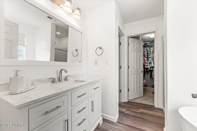 9311 Artis Way, Louisville, KY 40291 - full bathroom featuring vanity, wood finished floors, a spacious closet, and a freestanding tub