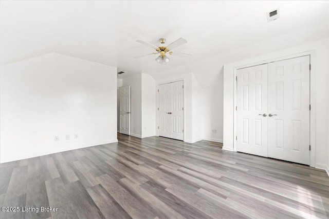 9311 Artis Way, Louisville, KY 40291 - unfurnished bedroom with multiple closets, wood finished floors, and ceiling fan