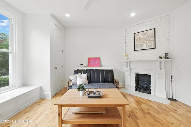 143 State St, Louisville, KY 40206 - living area with light wood-type flooring, a large fireplace, and recessed lighting