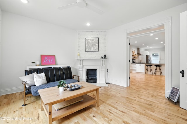 143 State St, Louisville, KY 40206 - living room featuring ceiling fan, light wood-style floors, a fireplace, and recessed lighting