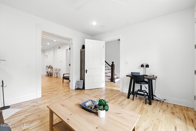 143 State St, Louisville, KY 40206 - living area featuring light wood finished floors, stairway, and recessed lighting