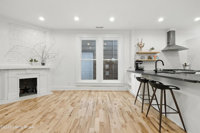143 State St, Louisville, KY 40206 - living area featuring light wood-type flooring, recessed lighting, and a fireplace with flush hearth