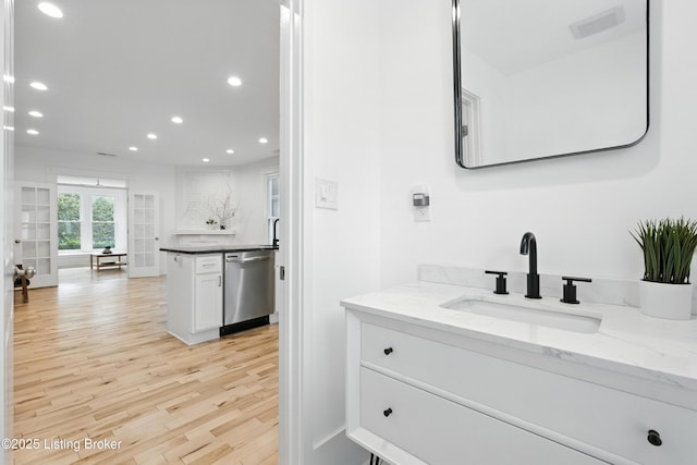 143 State St, Louisville, KY 40206 - bathroom with recessed lighting, vanity, and wood finished floors