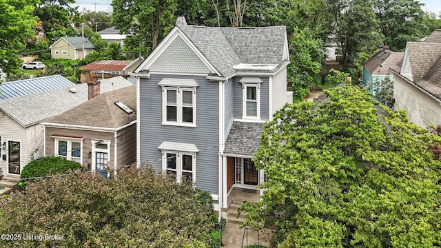 143 State St, Louisville, KY 40206 - victorian-style house featuring roof with shingles and view of wooded area