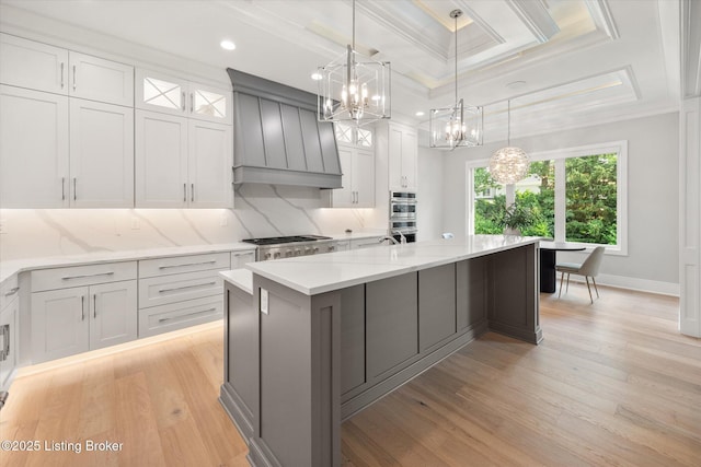 6511 Rosecliff Ct, Prospect, KY 40059 - kitchen with custom range hood, a chandelier, coffered ceiling, crown molding, and light wood-style floors