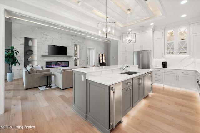 6511 Rosecliff Ct, Prospect, KY 40059 - kitchen featuring appliances with stainless steel finishes, gray cabinets, a fireplace, white cabinetry, and light wood-type flooring