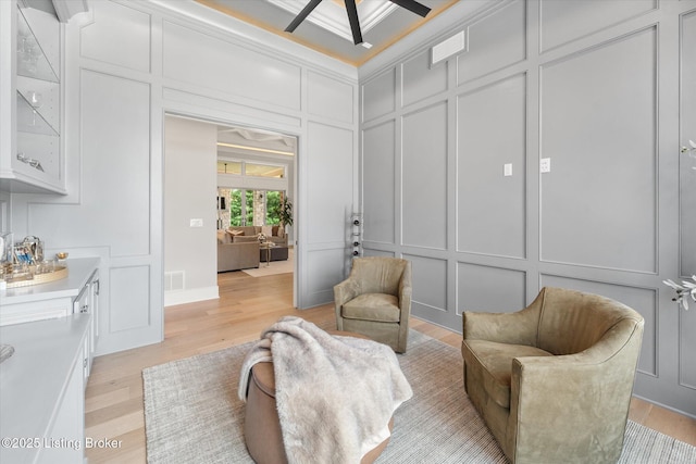 6511 Rosecliff Ct, Prospect, KY 40059 - living room featuring a decorative wall, light wood-type flooring, ceiling fan, and ornamental molding