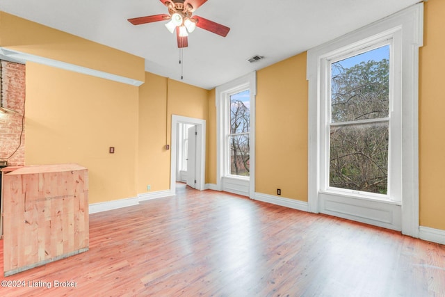 1131 S Brook St Apt 3, Louisville, KY 40203 - unfurnished room with wood finished floors, ceiling fan, and healthy amount of natural light