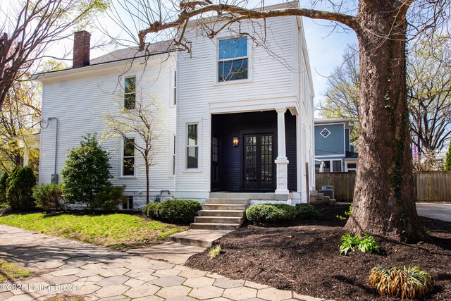 1293 Everett Ave, Louisville, KY 40204 - view of front facade featuring french doors and a chimney