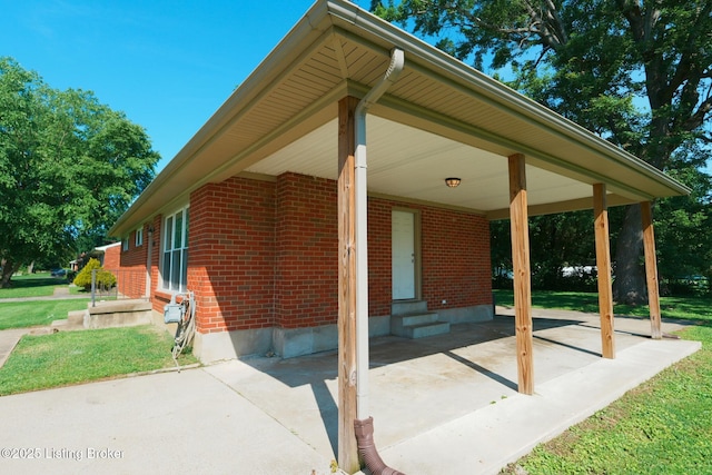 10104 Nanka Rd, Louisville, KY 40272 - view of patio / terrace featuring entry steps, an attached carport, and driveway
