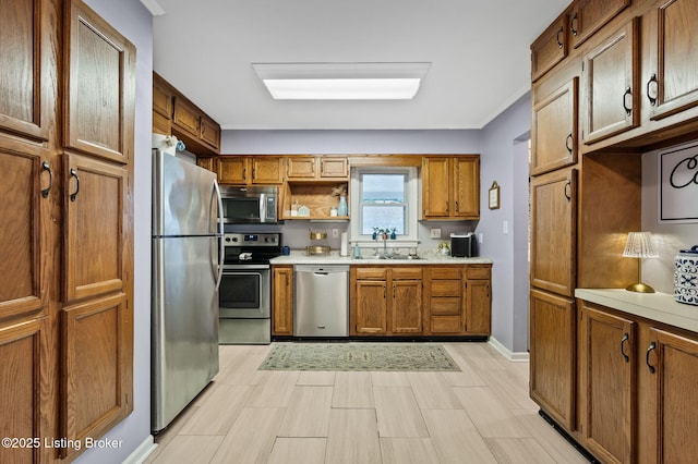 8433 Chase Rd, Louisville, KY 40258 - kitchen featuring stainless steel appliances, brown cabinetry, light countertops, open shelves, and light wood-style flooring