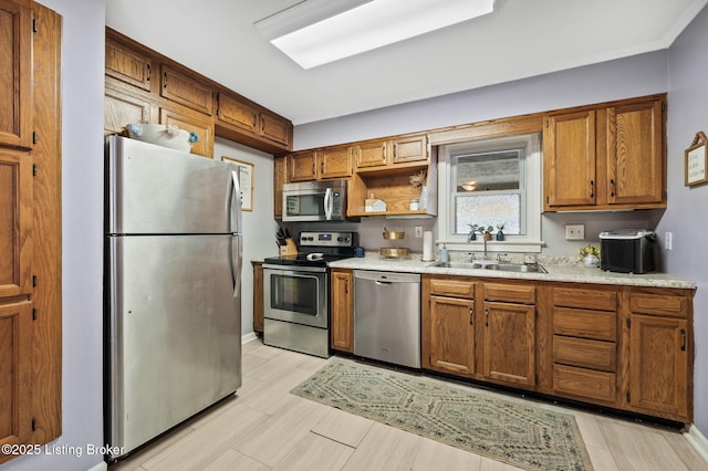 8433 Chase Rd, Louisville, KY 40258 - kitchen featuring appliances with stainless steel finishes, brown cabinetry, light countertops, light wood-type flooring, and open shelves