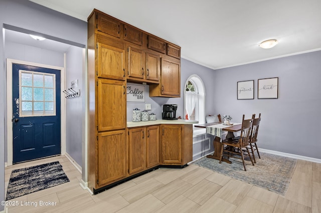 8433 Chase Rd, Louisville, KY 40258 - kitchen with plenty of natural light, brown cabinets, light countertops, and crown molding
