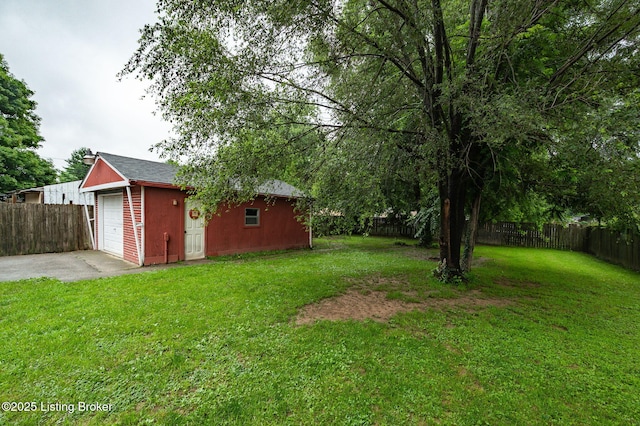 8433 Chase Rd, Louisville, KY 40258 - fenced backyard with an outdoor structure, concrete driveway, and a detached garage
