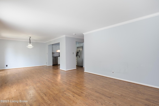 6503 Deep Creek Dr Unit 1, Prospect, KY 40059 - unfurnished living room with a chandelier, ornamental molding, and wood finished floors