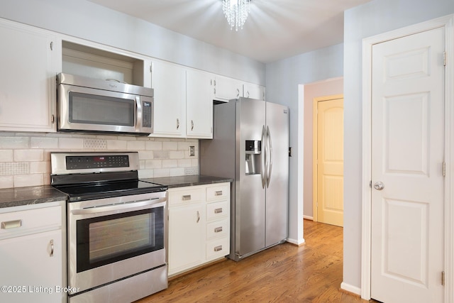 6503 Deep Creek Dr Unit 1, Prospect, KY 40059 - kitchen with stainless steel appliances, light wood-style flooring, backsplash, and white cabinets